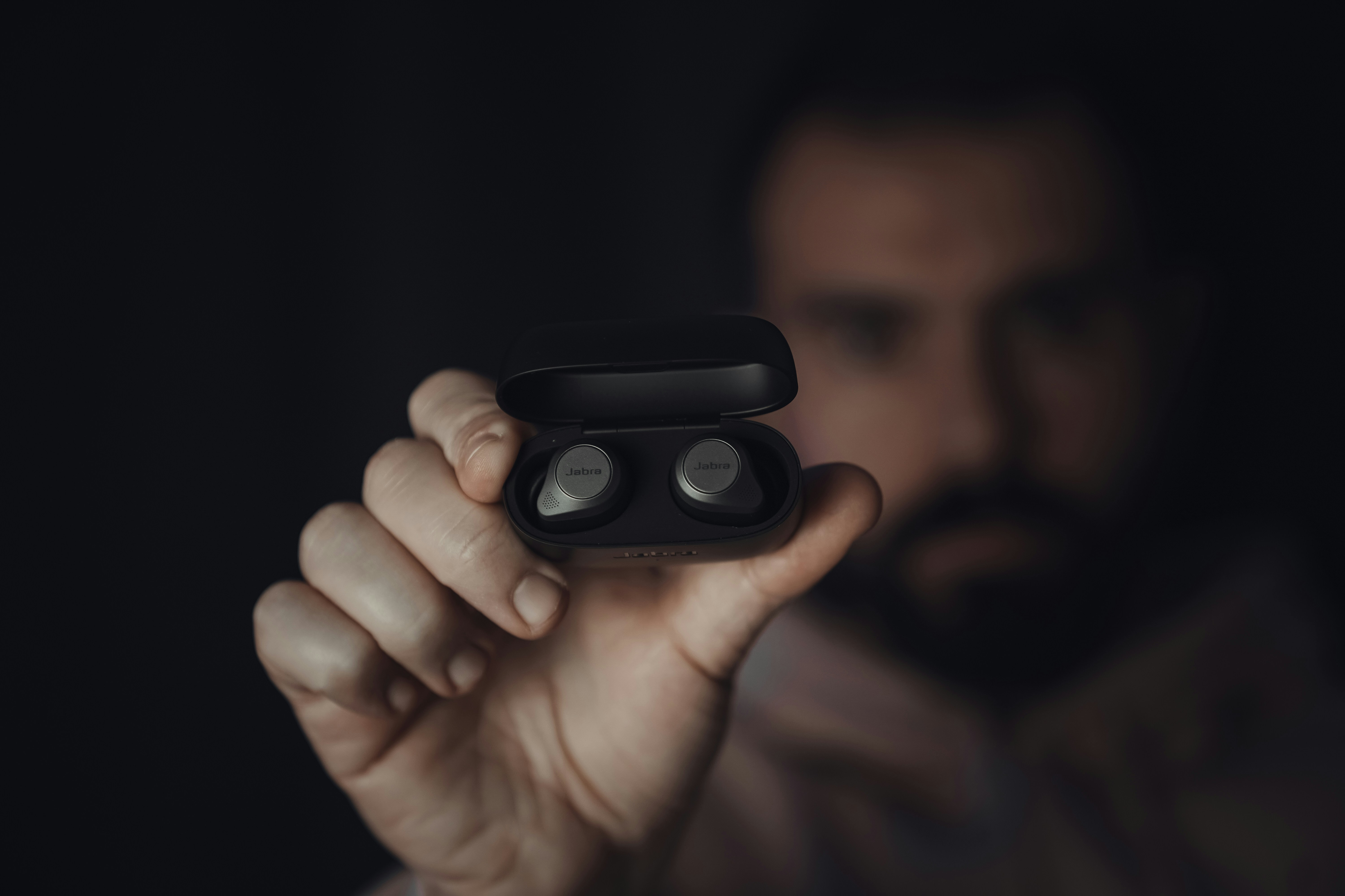 person holding black round device